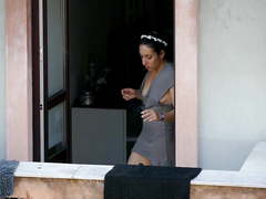 Neighbor shows downblouse on the balcony